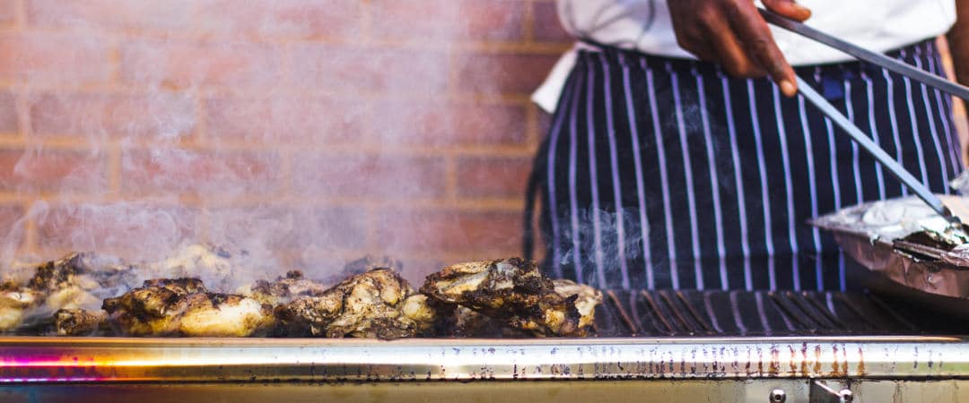 man barbecuing chicken