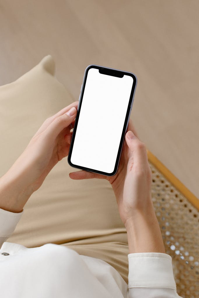 Woman holding smartphone with blank screen for mockup or design purposes, ideal for advertising.